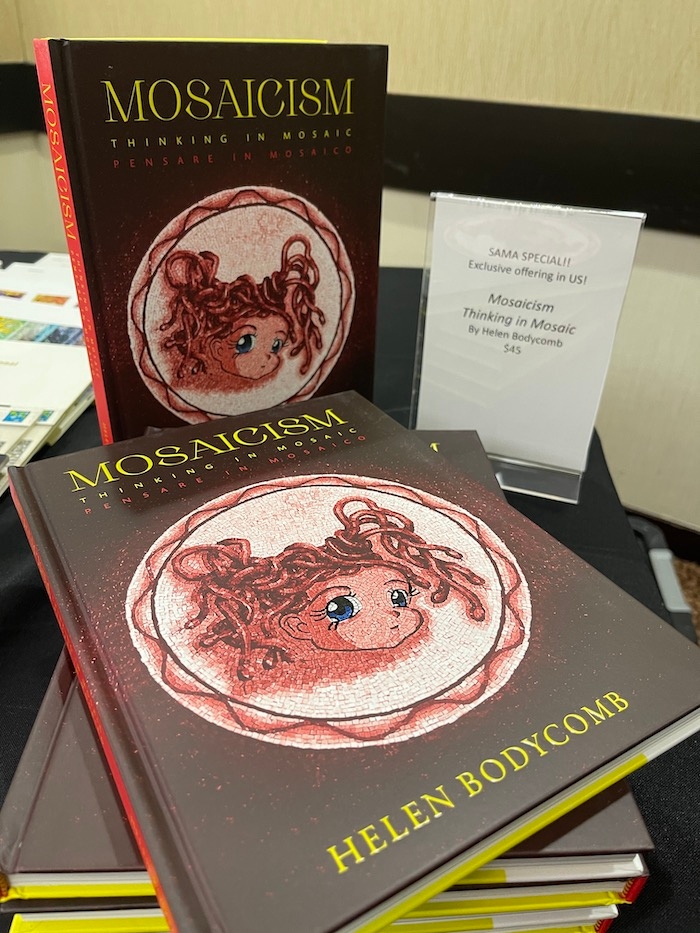 Product Description: Why do we lose ourselves in the act of making? Is the urge to create order and permanence the only desire when we fill a void with an object or colour?</br></br>In Mosaicism, Bodycomb draws on her experience as a visual artist and her ground-breaking research, to explain the human urge to ‘make special’. This intuitive act of assembling small, like parts, is one where the act of making is as important as the artefact made.</br></br>Drawing on the rich Hellenic origins of mosaic, Bodycomb gently takes the reader through an intriguing journey, combining fiction with non-fiction. Using imagery, prose, theoretical commentary, poetry and historical analysis, Mosaicism explores the act of making as a way of thinking, through the embedded memories that all materials contain. Bodycomb elevates mosaic for the reader, revealing it to be a potent contemporary art form.</br></br>A rich offering in both English and Italian, Mosaicism will appeal to all who are curious about the ancient practice of mosaic and its ongoing practice today.</br></br>FEATURES</br></br>English and Italian text</br>Part One – The Past</br>Part Two – Thinking in Mosaic</br>70+ colour images</br>Glossary</br>Guidelines for a public art project made with community</br>List of plates / bibliography</br></br>WHO THIS BOOK IS FOR</br></br>Mosaicism will engage both English and Italian speakers who are interested in exploring fresh concepts about making, mosaic, and materiality. This rich visual opus is compelling reading for all who are curious about the fluidity of material, and the gratifying act of making.</br> Mosaicism: Thinking in Mosaic by Helen Bodycomb
